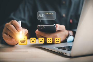 happy customer give feedback on satisfaction rating using smartphone app, selecting happy yellow face for digital survey to evaluate quality of positive business service delivery