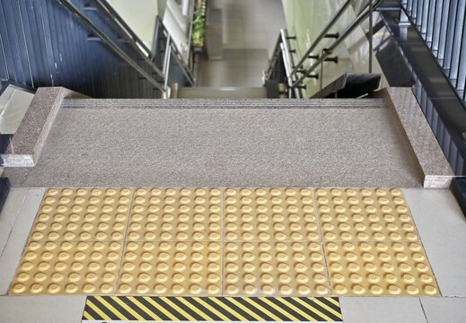 
Textured, non-slip entrance flooring on escalators in modern buildings. Assistive devices for people with disabilities in modern buildings.