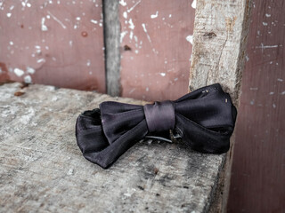 a bow tie lying on a broken wooden chair