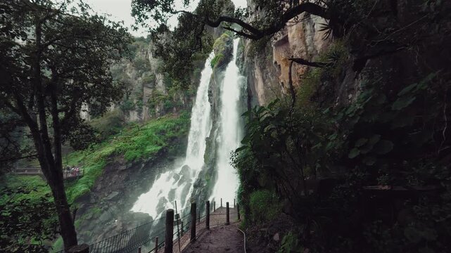 Brizas waterfall surrounded by cliffs and vegetation in Zacatl&aacute;n, Mexico