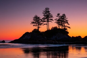 Coastal islet with trees silhouetted against a vibrant, colorful sunset over the ocean