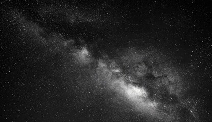 A grayscale image showcases the Milky Way, a luminous band of countless stars