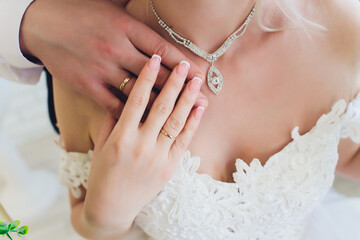 Intimate bridal pre ceremony moment, Caucasian bride personalizing her wedding attire, Soft natural lighting highlights tender bride preparing for her wedding ceremony