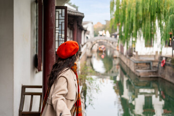 Young female tourist enjoying the view on Pingjiang Road a famous historic street and canal district in Suzhou, China