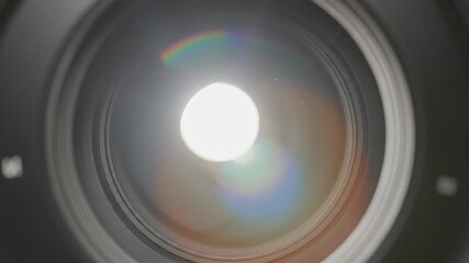 A mesmerizing closeup view inside a professional camera lens showcasing the intricate aperture blades as a brilliant light source creates stunning lens flares and optical effects highlighting the pre.