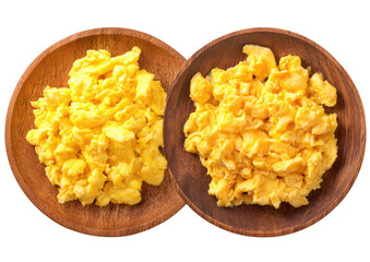 Two wooden bowls hold fluffy, golden scrambled eggs against a black backdrop