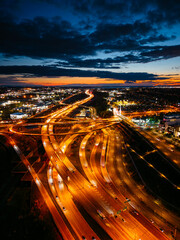 Fototapeta premium Aerial night view of Turcot Interchange in Montreal with glowing highways and city lights at dramatic blue hour. g.