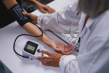 Healthcare professional checking patient blood pressure measuring