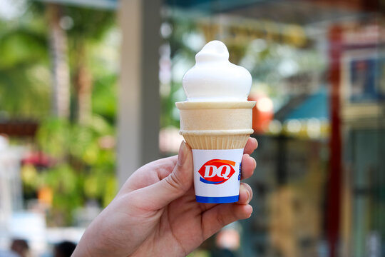 Tangerang, Indonesia - October 11, 2025: A hand holding the signature vanilla cone from Dairy Queen.