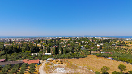 Didim, Turkey. Aerial drone flight over rural fields and houses towards Aegean Sea and Temple of Apollo. Aerial View