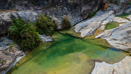 Jagueyes de Mayascon, a natural oasis with crystal clear pools surrounded by mountains in...