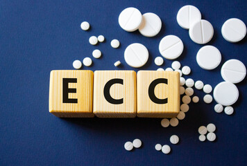 ECC symbol. Wooden cubes with words ECC Emergency Cardiovascular Care. Beautiful deep blue background. Healthcare and Emergency Cardiovascular Care concept. Copy space.