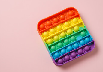 Rainbow pop it toy on pastel background