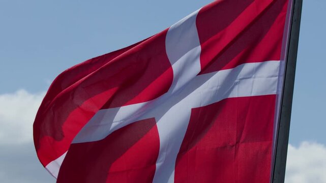 Close Up of Danish Flag Waving Against a Blue Sky