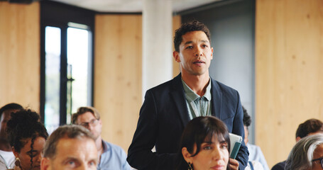 Business, conference and man with questions, audience and listening with skills training. People,...
