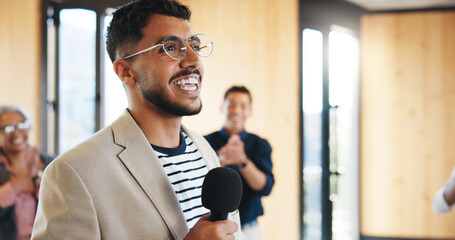 Speaker, man and talking in seminar with mic for professional training, knowledge and career growth. Happy, presenter and person in workshop with tech for speech, tradeshow presentation and advice.