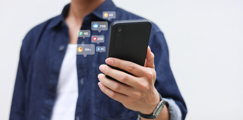 close up young man hand hold smartphone and using social media network to check notification and click like and share ,comment with other for modern and people technology and lifestyle concept