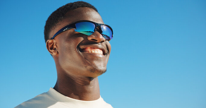 Smile, sunglasses and travel with black man outdoor for summer vacation, relax and fashion. Happiness, holiday trip and uv protection gear with person in nature for mockup space, tourism and blue sky