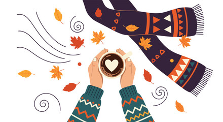 Top down view of hands holding a cup of coffee with a heart surrounded by autumn leaves and a warm patterned scarf for cozy fall vibes.