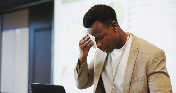 Business, nervous and black man with anxiety, speaker and laptop for financial data. African person, presenter and employee with stress, feedback or sweating with concern, inflation stats or pressure