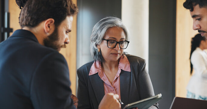 Discussion, meeting or people at seminar with tablet, company insight or proposal for b2b plan. Collaboration, feedback or businesspeople with tech, networking or contract development at trade show - Powered by Adobe