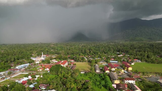A town with houses and a mosque. The sky is cloudy and rain. Aerial view Yan, Kedah