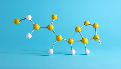 Molecular model with yellow and white atoms on blue