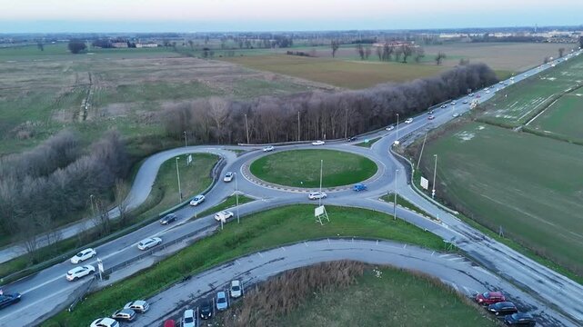 Aerial view of a busy roundabout intersection on a cloudy day in Italy