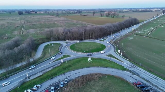 Aerial view of a busy roundabout intersection on a cloudy day in Italy