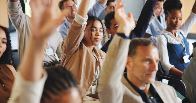 Business people, hands raised or question at conference for corporate training, interaction or engagement at seminar. Audience, group or employees with FAQ, ask or insight at convention or workshop