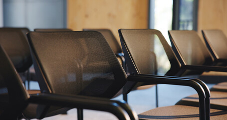 Audience, business and empty room with chairs at seminar for meeting, lecture and convention. Trade...