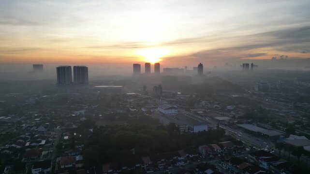 Larkin skyline with a large building in the middle. The sun is setting and the sky is cloudy
