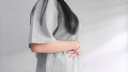 Woman holding stomach in pain, abdominal pain and stomach ache concept