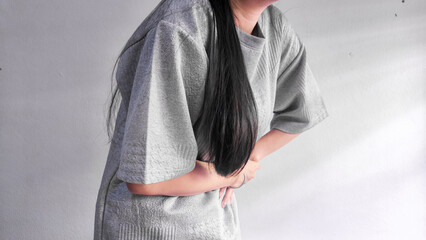 Woman holding stomach in pain, abdominal pain and stomach ache concept