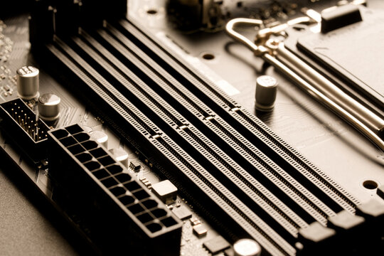 Detailed view of sockets for random access memory on a printed circuit board. Background for PC building, hardware upgrades, or high-tech price inflation. Photo