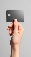 Human hand showing a blank black credit card with a chip, ready for payment