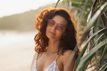 Beautiful Young Woman in Sunglasses Relaxing on Tropical Beach 