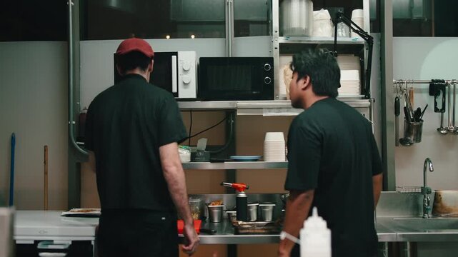 Chef cooking in a professional takeaway kitchen