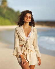 Smiling Young Woman in Boho Outfit Enjoying Tropical Beach Walk