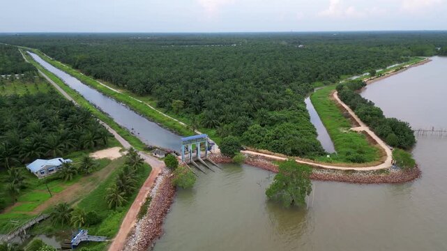A river with river pump gate over it. Aerial Pantai Parit Hailam, Batu Pahat.