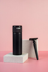 Black cosmetic product or sunscreen cosmetic with stylish props on pink background.