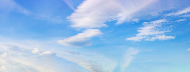 Layered cloud formations in textured blue sky—ideal as a natural atmospheric background with depth, softness, and visual scale for design, presentation, or compositional use.
