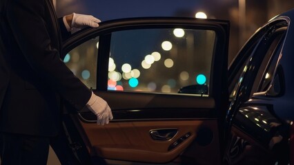 Chauffeur Service Opening Car Door at Night with City Lights Backdrop.