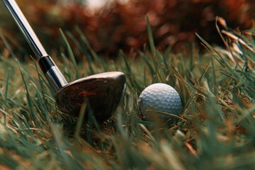Close-up view of a golf club resting on lush green grass beside a white golf ball, capturing the essence of the game and the anticipation of the next swing