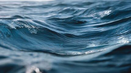 An abstract close-up shot of ocean water, showcasing its texture and movement. The waves create a mesmerizing display of liquid surface