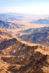 The mountains are brown and the sky is blue