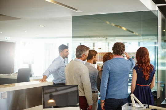 Back, documents and team of business man in office for funding meeting, discussion and research. Collaboration, brainstorming pitch and account graph with employees in agency for review together