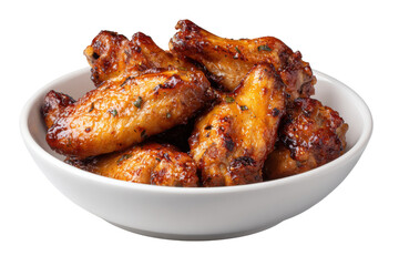 Crispy golden brown roasted chicken wings with herbs in white bowl closeup