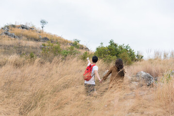 Asian attractive couple travelling together hiking, healthy man and female backpack tourists happy...
