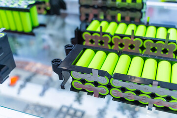 Metal parts with shiny steel cylindrical surface closeup. disassembled lithium ion form factor cell battery pack